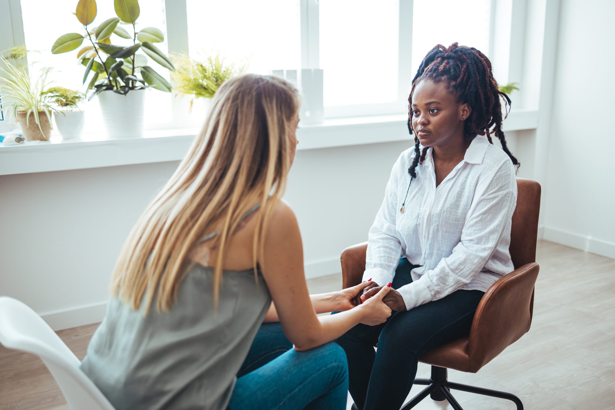 Psychiatrist helping sad African American woman