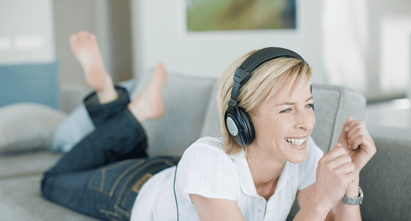 Happy woman enjoying audio content