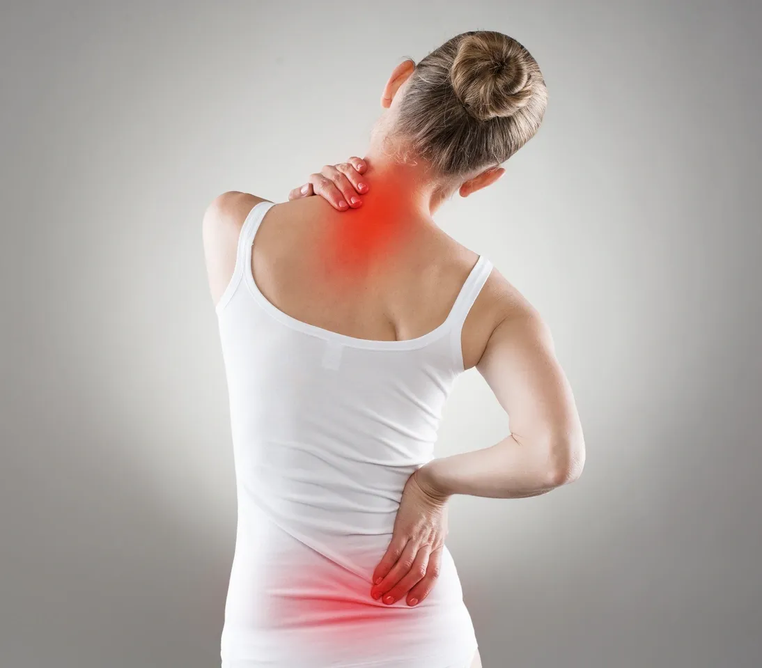 Woman holding neck in pain