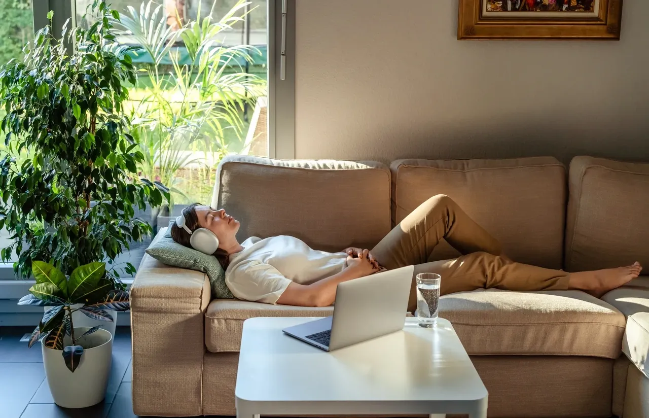 Woman enjoying music on couch