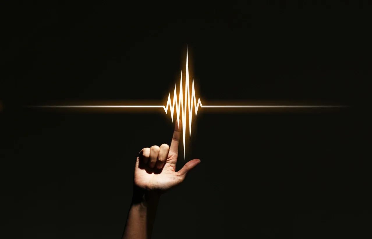 Finger interacting with illuminated waveform.