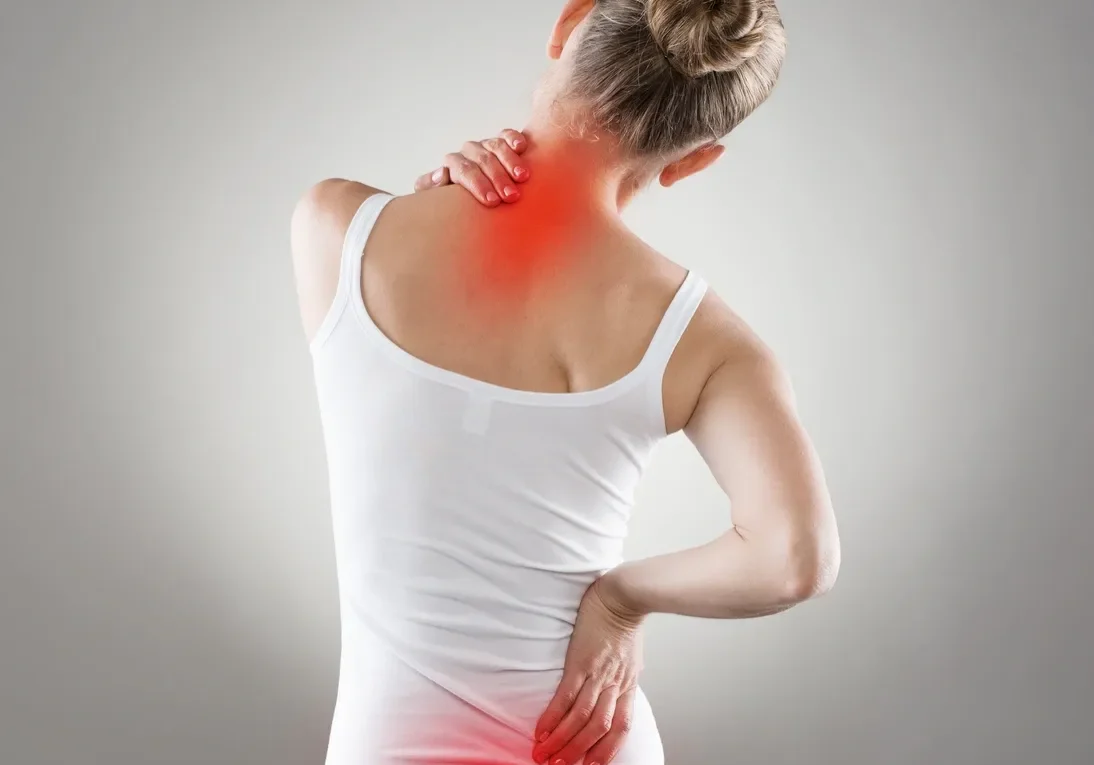 Woman holding neck in pain