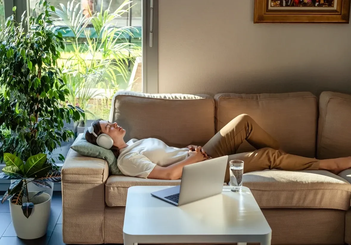 Woman enjoying music on couch