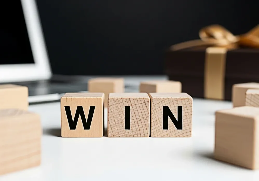 Cubes with "win" and a wrapped present