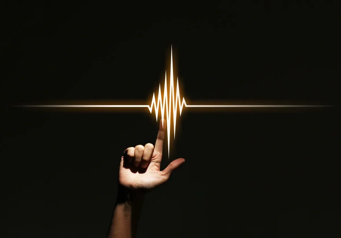 Finger interacting with illuminated waveform.